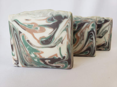 Cedar and Amber Handmade Soap -  This is a fresh scent rich with pine notes blended with warm cinnamon and clove.  A hearty base of cedarwood is mellowed with a gentle amber scent.  Ingredients:  Olive oil, coconut oil, organic palm oil, water, sodium hydroxide, shea butter, sweet almond oil, meadowfoam oil, caster oil, fragrance, kaolin clay, skin-safe colorants