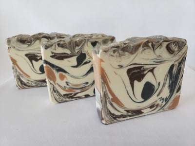 Bay Rum Handmade Soap - Classic cologne aftershave scent with Allspice, capers, cloves, nutmeg, crushed orange, pine needles, and a touch of patchouli and vanilla.  Ingredients:  Olive oil, coconut oil, organic palm oil, water, sodium hydroxide, shea butter, sweet almond oil, meadowfoam oil, caster oil, fragrance, kaolin clay, skin-safe colorants
