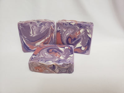 Lilac Blossoms Handmade Soap - Capture the lovely scent of fresh blooming lilacs with this soap.  It smells just like a breath of sweet, summer air when the blossoms are in full bloom.  A soothing, relaxing fragrance you are sure to enjoy!  Ingredients:  Olive Oil, Coconut Oil, Organic Palm Oil (ethically and sustainably sourced), Water, Sodium Hydroxide, Shea Butter, Meadowfoam Oil, Sweet Almond Oil, Castor Oil, Fragrance, Kaolin Clay, Skin-Safe Colorants